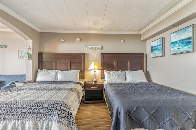 bedroom with crown molding and wood-type flooring