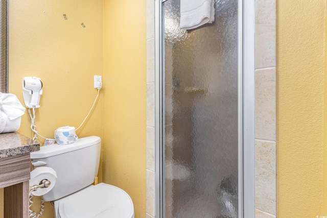 bathroom featuring toilet and walk in shower