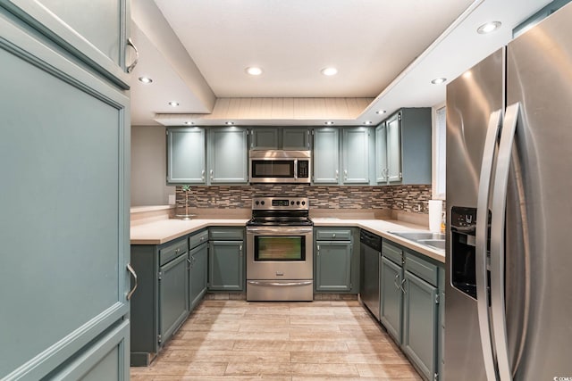 775 Plantation Dr Unit 59, Little River, SC 29566 - kitchen with appliances with stainless steel finishes, light countertops, light wood-style flooring, backsplash, and recessed lighting