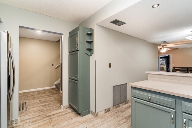 775 Plantation Dr Unit 59, Little River, SC 29566 - kitchen featuring green cabinets, stainless steel fridge with ice dispenser, light wood-type flooring, ceiling fan, and light countertops