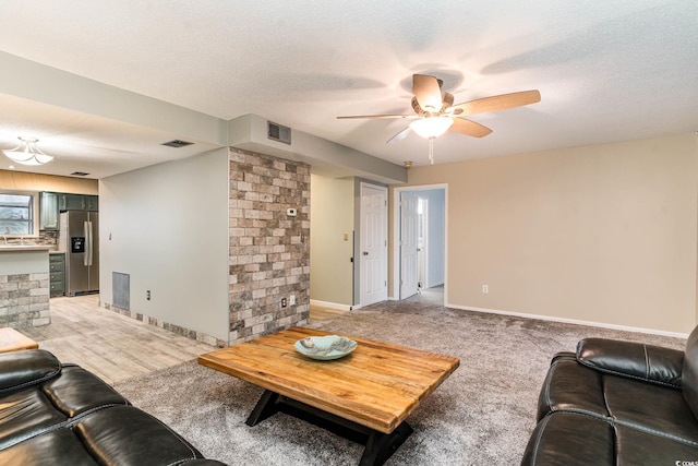 775 Plantation Dr Unit 59, Little River, SC 29566 - living room with ceiling fan, light colored carpet, and a textured ceiling