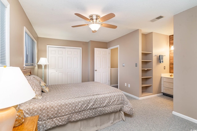 775 Plantation Dr Unit 59, Little River, SC 29566 - bedroom featuring carpet floors, a closet, a ceiling fan, and ensuite bath