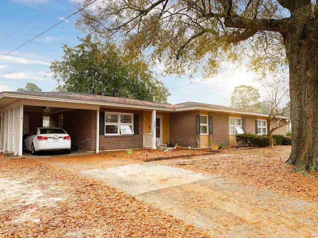 ranch-style house featuring a carport