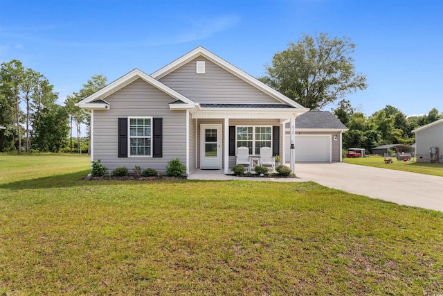 view of front of house featuring a porch, a front yard, and a garage