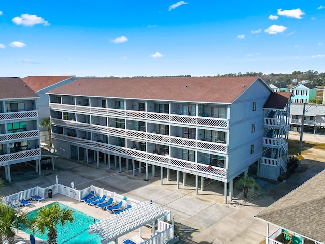 view of building exterior featuring a community pool