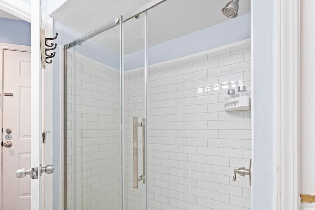 bathroom with a shower with shower door