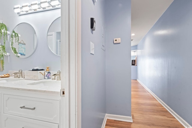 bathroom with wood-type flooring and vanity