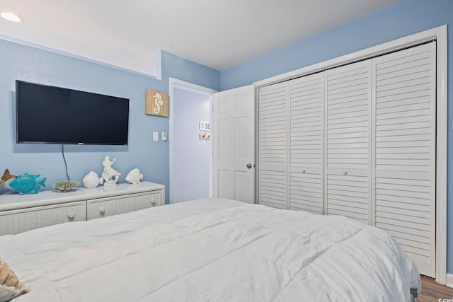 bedroom featuring hardwood / wood-style floors and a closet