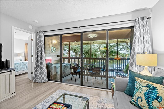 living room featuring wood-type flooring and a textured ceiling