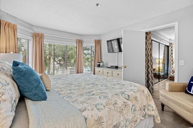 bedroom featuring a textured ceiling and light wood-type flooring