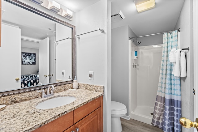 bathroom with vanity, toilet, wood-type flooring, and walk in shower