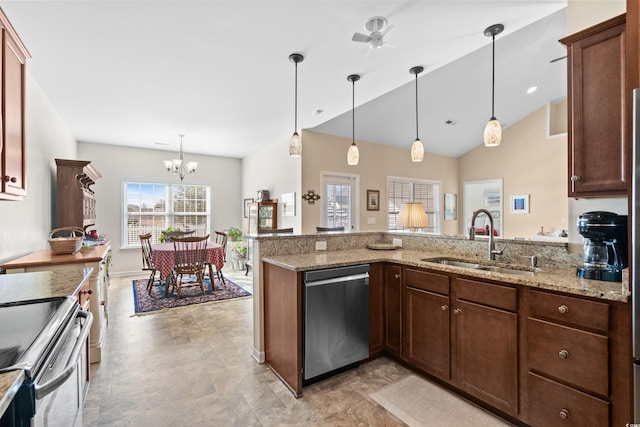 kitchen featuring lofted ceiling, sink, hanging light fixtures, light stone counters, and stainless steel appliances