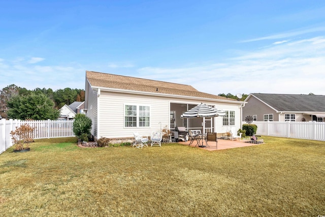 back of house featuring a yard and a patio