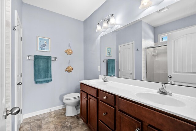 bathroom with vanity, toilet, and walk in shower