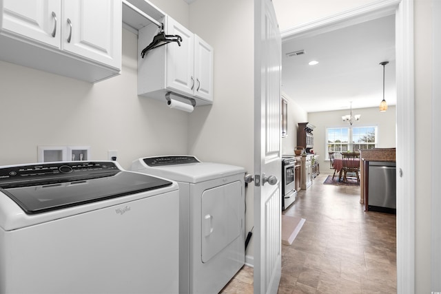 laundry room with cabinets, separate washer and dryer, and an inviting chandelier