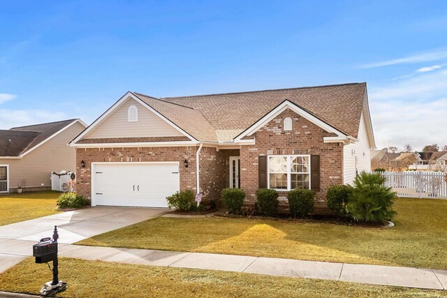 view of front facade with a front yard and a garage