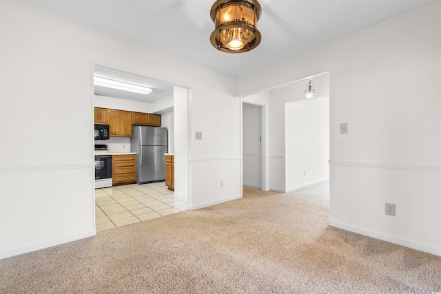 kitchen featuring light carpet, stainless steel fridge, and white range with electric stovetop