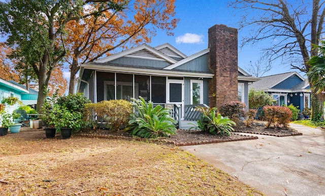 bungalow-style home with a sunroom