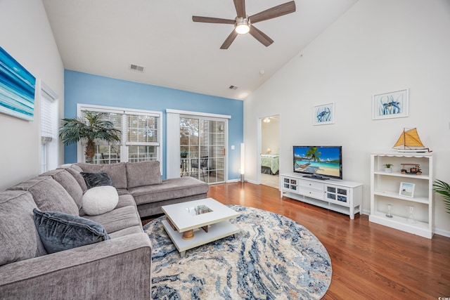 living room featuring ceiling fan, dark wood-type flooring, and high vaulted ceiling