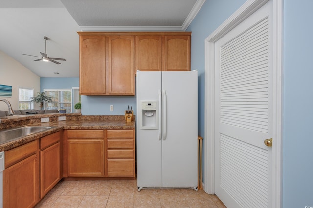 kitchen with lofted ceiling, white appliances, sink, light tile patterned floors, and ornamental molding