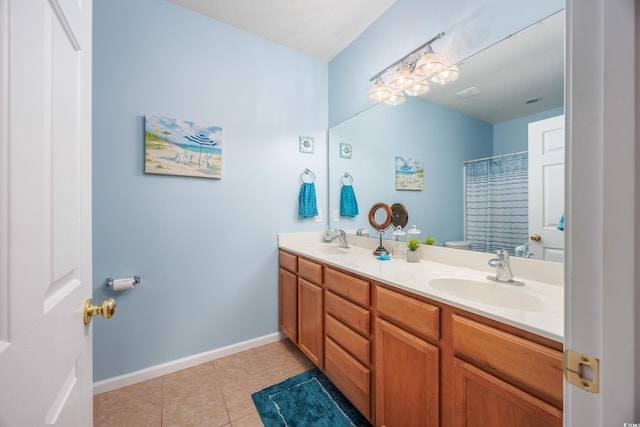 bathroom with tile patterned flooring, vanity, and walk in shower