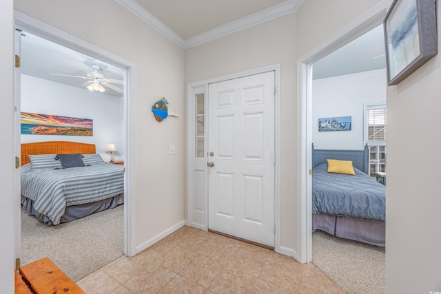 carpeted bedroom featuring ceiling fan and crown molding