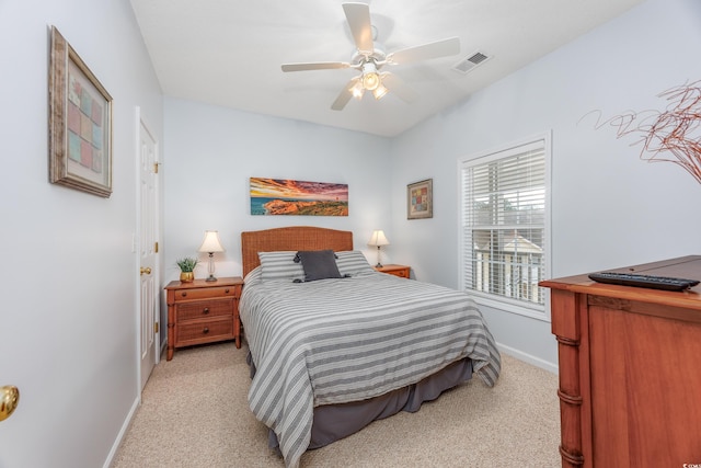 bedroom with ceiling fan and light carpet