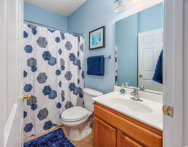 bathroom with tile patterned flooring, vanity, toilet, and a shower with shower curtain