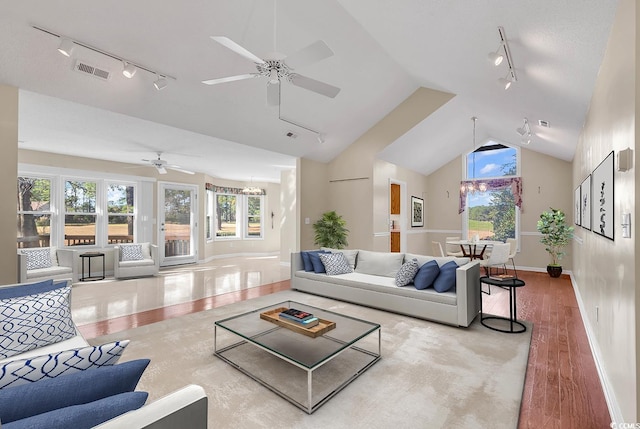 living room with rail lighting, light hardwood / wood-style floors, and ceiling fan