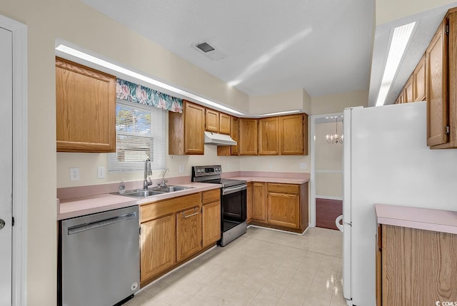 kitchen with sink, stainless steel appliances, and a chandelier