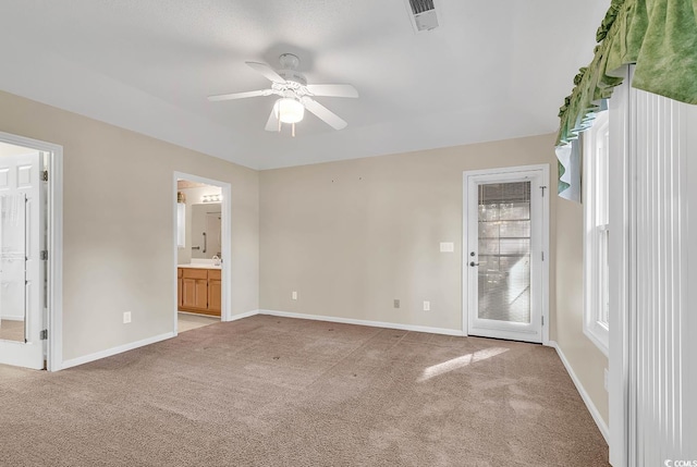 carpeted spare room with ceiling fan