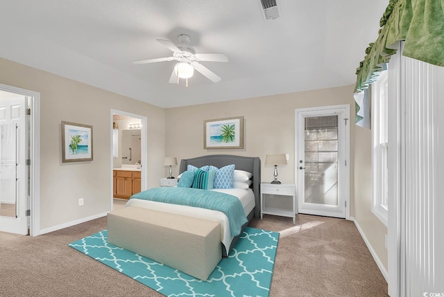 carpeted bedroom with connected bathroom and ceiling fan