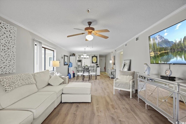 living room with hardwood / wood-style flooring, ceiling fan, and a textured ceiling