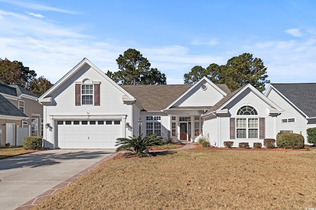 view of front property featuring a front lawn and a garage