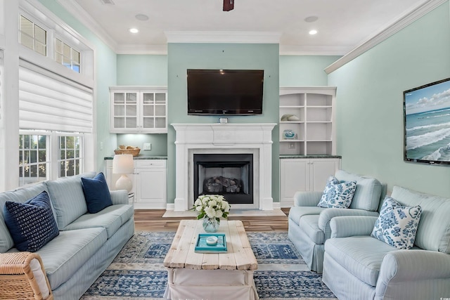 living room with crown molding and light hardwood / wood-style floors