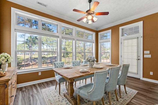 dining room with ceiling fan, wood-type flooring, and crown molding