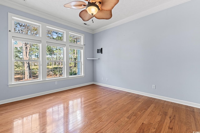 unfurnished room featuring ceiling fan, wood-type flooring, and crown molding