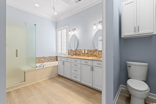 full bathroom with hardwood / wood-style floors, vanity, tasteful backsplash, ornamental molding, and plus walk in shower