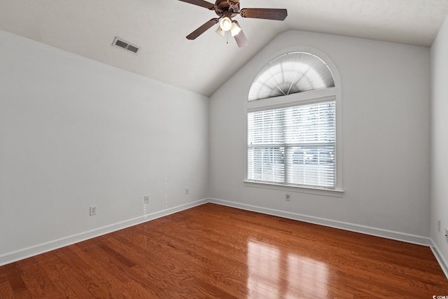 spare room with ceiling fan, vaulted ceiling, and hardwood / wood-style floors