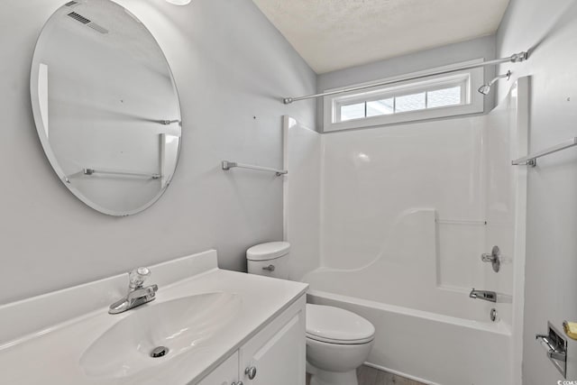 full bathroom with a textured ceiling, toilet, vanity, and shower / tub combination