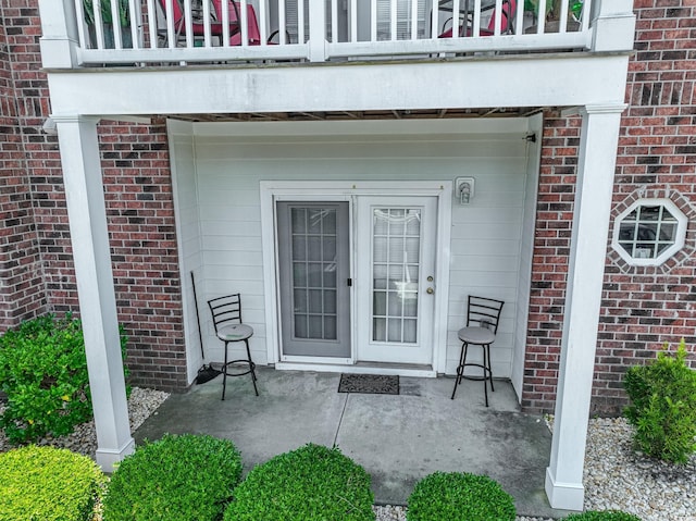 entrance to property featuring a patio area and a balcony