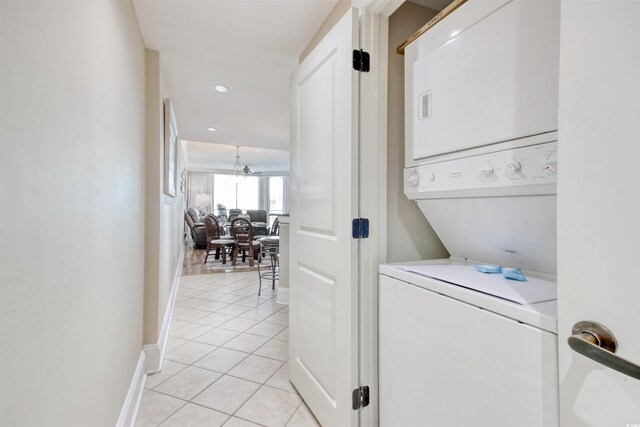 603 S Ocean Blvd Unit 1002, North Myrtle Beach, SC 29582 - washroom featuring estacked washer and dryer, light tile patterned floors, baseboards, a chandelier, and recessed lighting