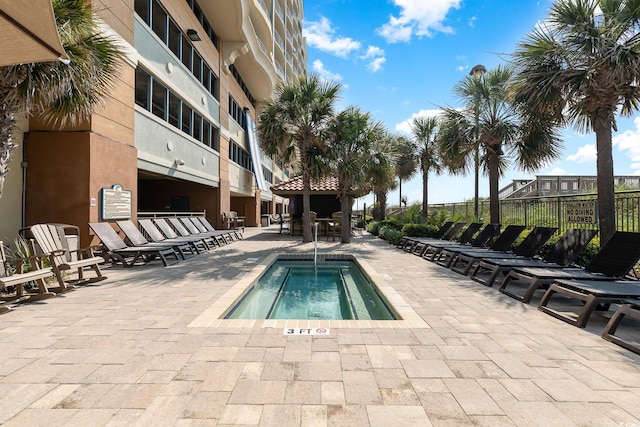 view of pool featuring a patio area and a hot tub