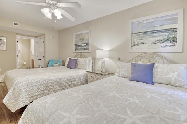 603 S Ocean Blvd Unit 1002, North Myrtle Beach, SC 29582 - bedroom featuring ensuite bathroom, a ceiling fan, and wood finished floors