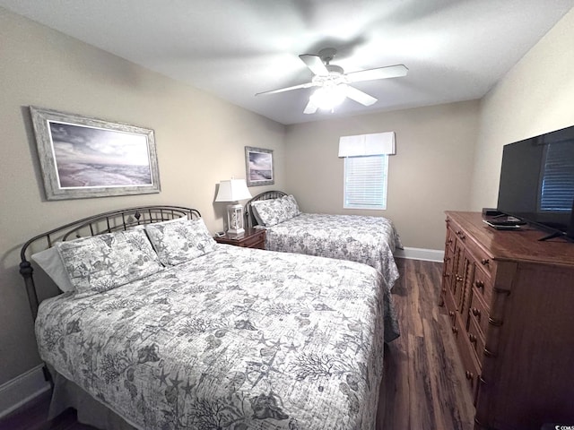 bedroom featuring ceiling fan and dark hardwood / wood-style flooring