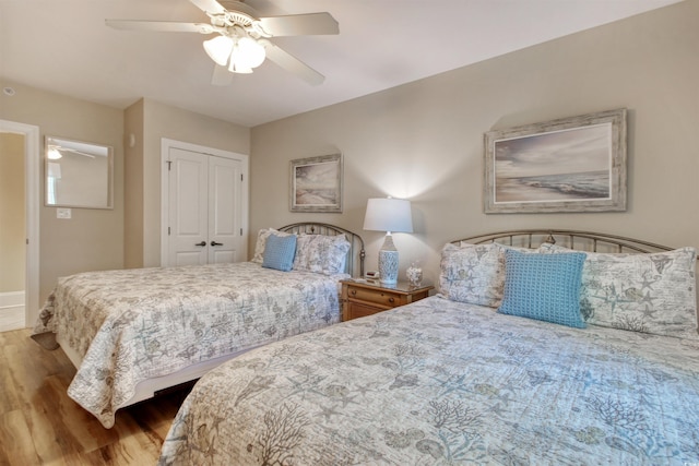 603 S Ocean Blvd Unit 1002, North Myrtle Beach, SC 29582 - bedroom featuring wood finished floors, a ceiling fan, a closet, and baseboards