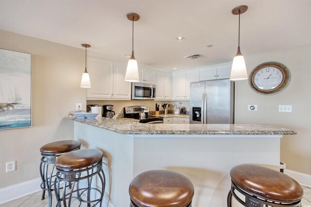 603 S Ocean Blvd Unit 1002, North Myrtle Beach, SC 29582 - kitchen with appliances with stainless steel finishes, baseboards, a peninsula, and white cabinets