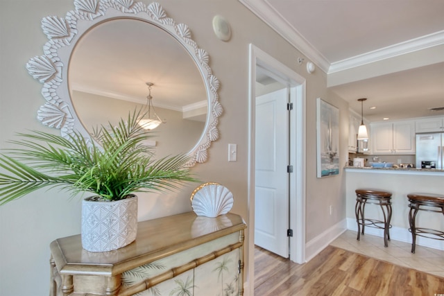 603 S Ocean Blvd Unit 1002, North Myrtle Beach, SC 29582 - hallway featuring light wood-style flooring, ornamental molding, and baseboards