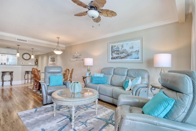 603 S Ocean Blvd Unit 1002, North Myrtle Beach, SC 29582 - living area featuring wood finished floors, ornamental molding, a ceiling fan, and baseboards