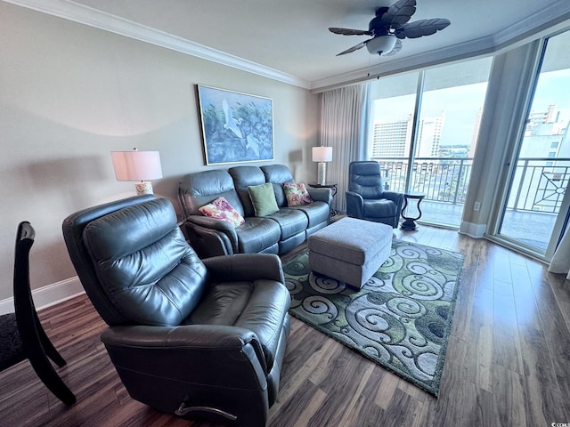 living room with dark hardwood / wood-style flooring, ceiling fan, and crown molding